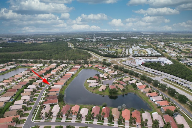 drone / aerial view with a residential view and a water view