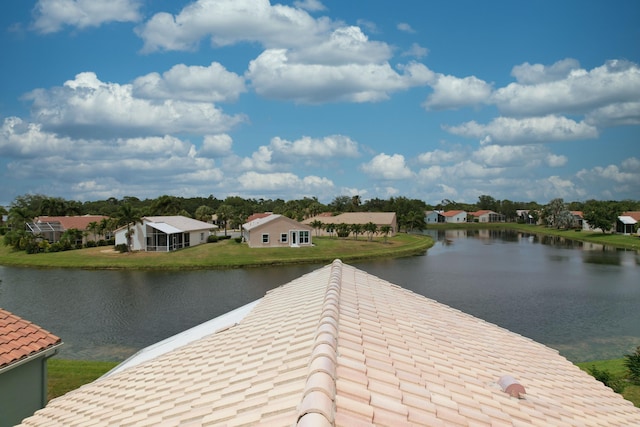 view of dock with a residential view, a lawn, and a water view