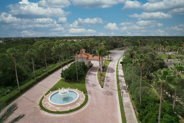 bird's eye view with a wooded view