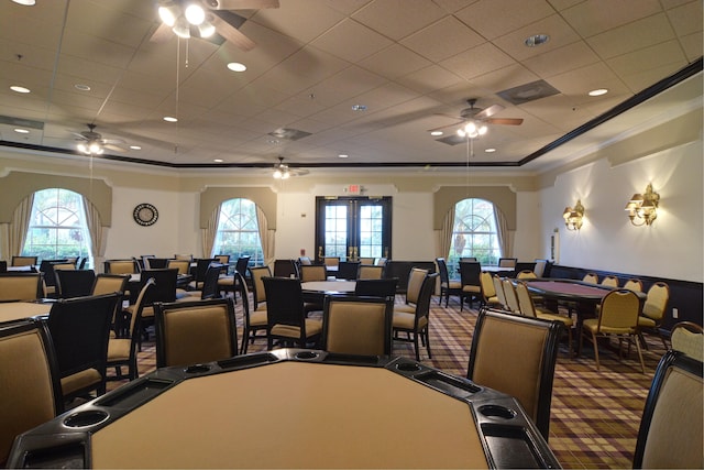 dining room with a paneled ceiling, a ceiling fan, crown molding, and carpet floors
