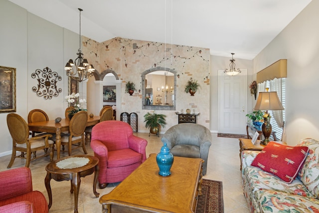 living room featuring baseboards, arched walkways, an inviting chandelier, and vaulted ceiling