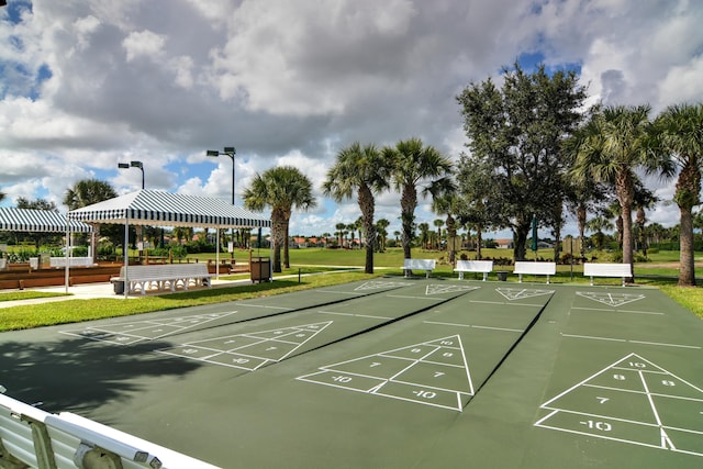 view of community with a lawn, a gazebo, and shuffleboard