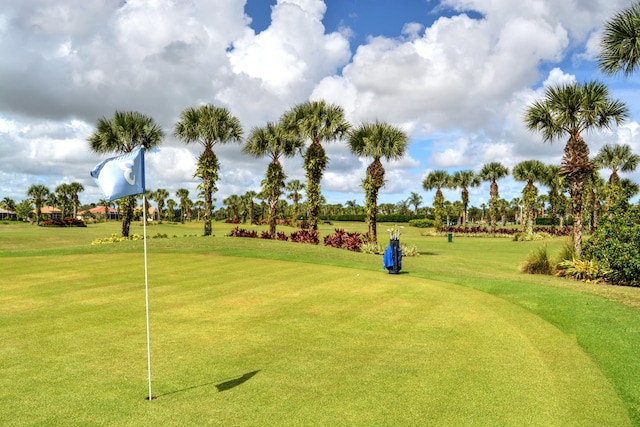 view of property's community with a lawn and golf course view
