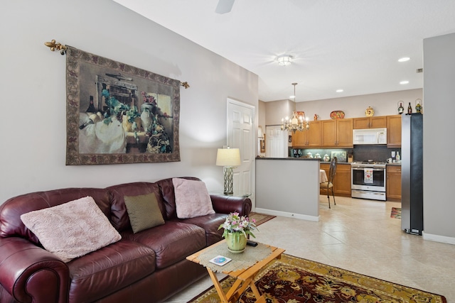 living area with light tile patterned floors, a chandelier, recessed lighting, and baseboards