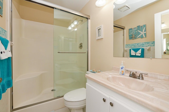 13 Lake Vista Trl Unit 202, Port Saint Lucie, FL 34952 - bathroom with visible vents, a shower stall, toilet, and vanity