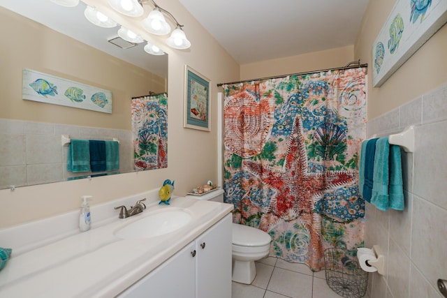 13 Lake Vista Trl Unit 202, Port Saint Lucie, FL 34952 - full bath featuring a shower with shower curtain, toilet, tile walls, vanity, and tile patterned flooring