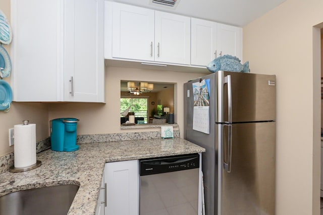 13 Lake Vista Trl Unit 202, Port Saint Lucie, FL 34952 - kitchen featuring an inviting chandelier, white cabinetry, stainless steel appliances, and light stone counters