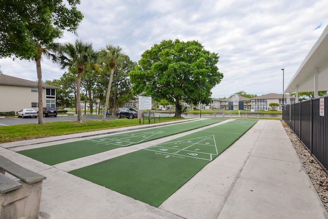 13 Lake Vista Trl Unit 202, Port Saint Lucie, FL 34952 - view of property's community featuring a residential view, shuffleboard, and fence