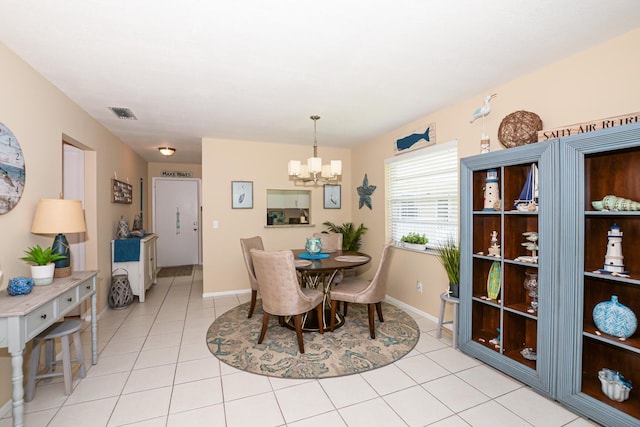 13 Lake Vista Trl Unit 202, Port Saint Lucie, FL 34952 - dining area featuring light tile patterned floors, visible vents, a chandelier, and baseboards