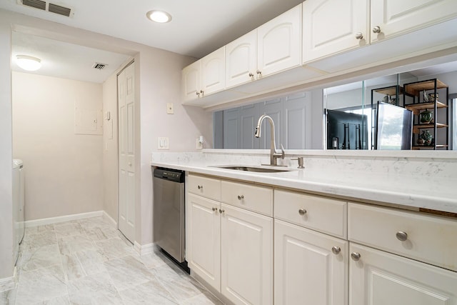 kitchen featuring stainless steel dishwasher, a sink, baseboards, and visible vents