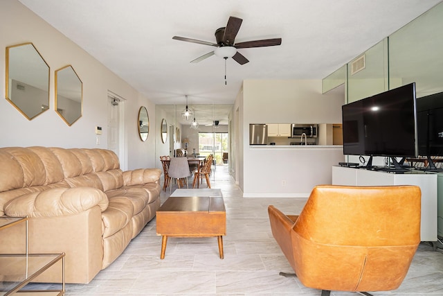 living room featuring a ceiling fan and visible vents