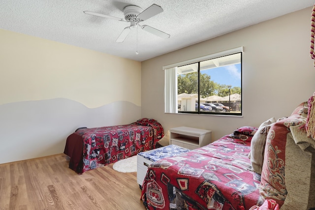901 Club Dr, Palm Beach Gardens, FL 33418 - bedroom with a textured ceiling, ceiling fan, and wood finished floors