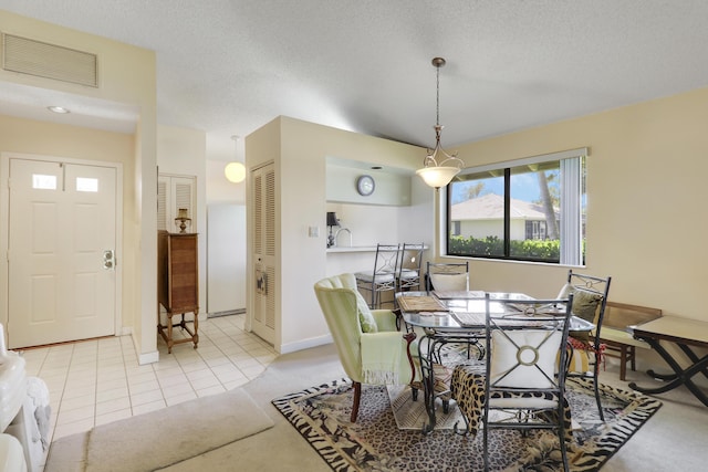 901 Club Dr, Palm Beach Gardens, FL 33418 - dining space with a textured ceiling, visible vents, tile patterned floors, baseboards, and carpet