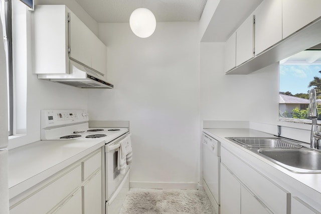901 Club Dr, Palm Beach Gardens, FL 33418 - kitchen featuring white appliances, light countertops, white cabinetry, under cabinet range hood, and a sink
