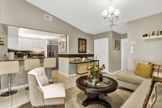 136 Centennial Ct, Deerfield Beach, FL 33442 - living area featuring lofted ceiling, visible vents, light tile patterned floors, baseboards, and a notable chandelier
