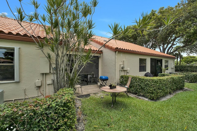 136 Centennial Ct, Deerfield Beach, FL 33442 - rear view of property featuring a tile roof, a yard, a patio area, and stucco siding