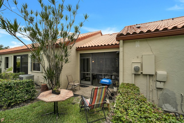 136 Centennial Ct, Deerfield Beach, FL 33442 - back of property featuring a tile roof, central AC unit, a sunroom, and stucco siding