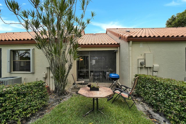 136 Centennial Ct, Deerfield Beach, FL 33442 - back of property with a tiled roof, a sunroom, central AC, and stucco siding