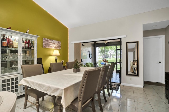 136 Centennial Ct, Deerfield Beach, FL 33442 - dining room with baseboards, vaulted ceiling, and light tile patterned floors