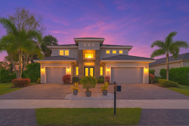 7015 NW 27th Ave, Boca Raton, FL 33496 - view of front of property featuring a tile roof, stucco siding, decorative driveway, and an attached garage