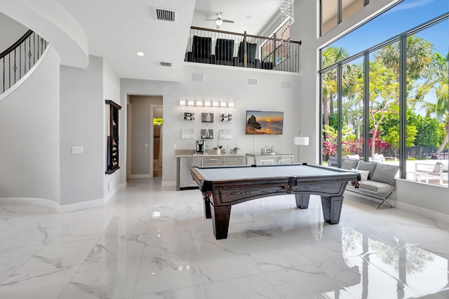 7015 NW 27th Ave, Boca Raton, FL 33496 - rec room with plenty of natural light, marble finish floor, and baseboards