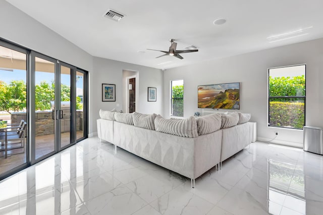 7015 NW 27th Ave, Boca Raton, FL 33496 - living room with a healthy amount of sunlight, visible vents, a ceiling fan, and marble finish floor