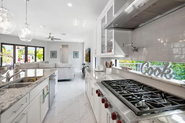 7015 NW 27th Ave, Boca Raton, FL 33496 - kitchen featuring tasteful backsplash, marble finish floor, extractor fan, appliances with stainless steel finishes, and open floor plan