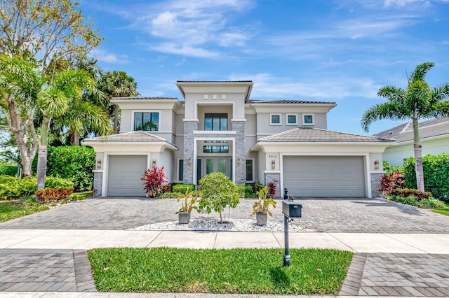 7015 NW 27th Ave, Boca Raton, FL 33496 - prairie-style house with stucco siding, decorative driveway, and a garage