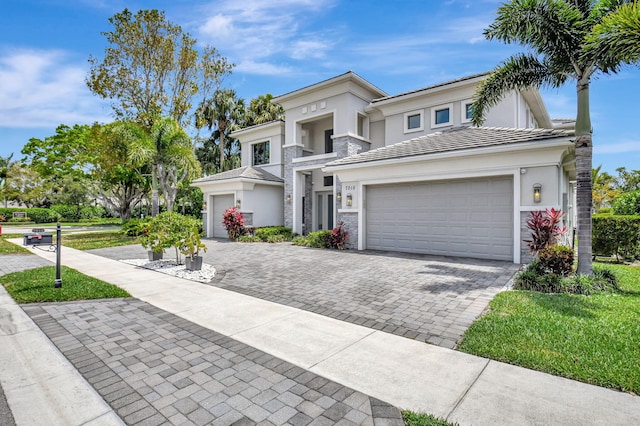 7015 NW 27th Ave, Boca Raton, FL 33496 - view of front of home featuring stucco siding, decorative driveway, a tile roof, a balcony, and an attached garage
