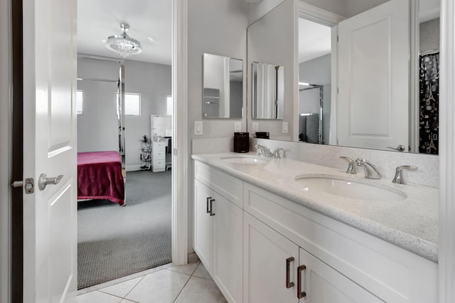 7015 NW 27th Ave, Boca Raton, FL 33496 - ensuite bathroom featuring double vanity, ensuite bath, tile patterned flooring, and a sink