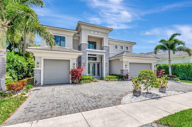 7015 NW 27th Ave, Boca Raton, FL 33496 - prairie-style house with a garage, stucco siding, and decorative driveway