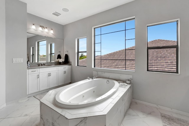 7015 NW 27th Ave, Boca Raton, FL 33496 - bathroom featuring a whirlpool tub, marble finish floor, vanity, baseboards, and visible vents