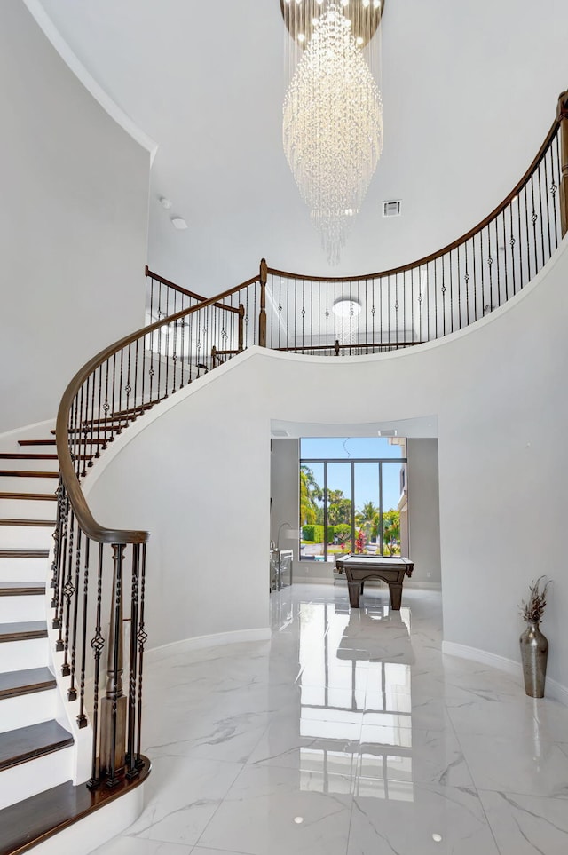 7015 NW 27th Ave, Boca Raton, FL 33496 - staircase featuring a towering ceiling, marble finish floor, an inviting chandelier, and visible vents