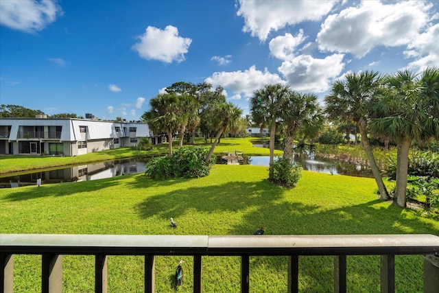 view of community featuring a water view and a lawn