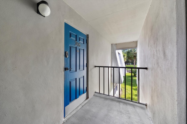 doorway to property featuring stucco siding