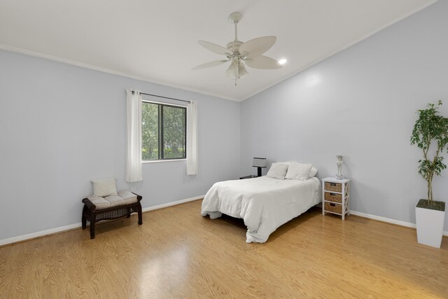 bedroom with light wood-style floors, a ceiling fan, and baseboards