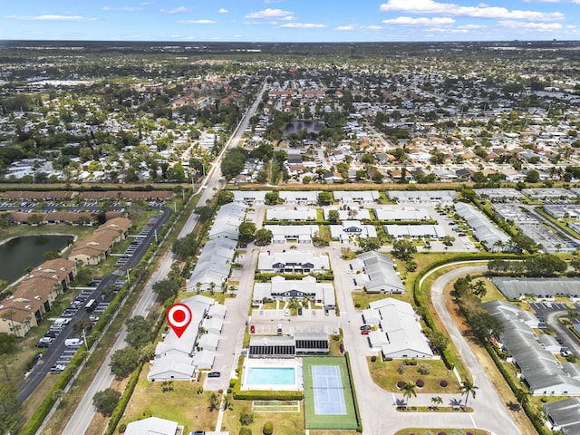 birds eye view of property with a water view and a residential view