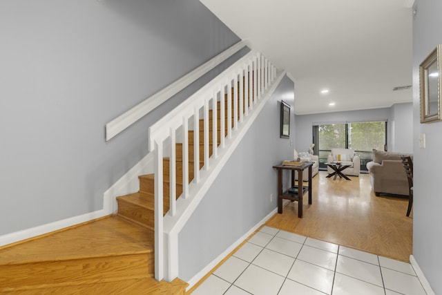 stairs with baseboards, visible vents, recessed lighting, and tile patterned floors