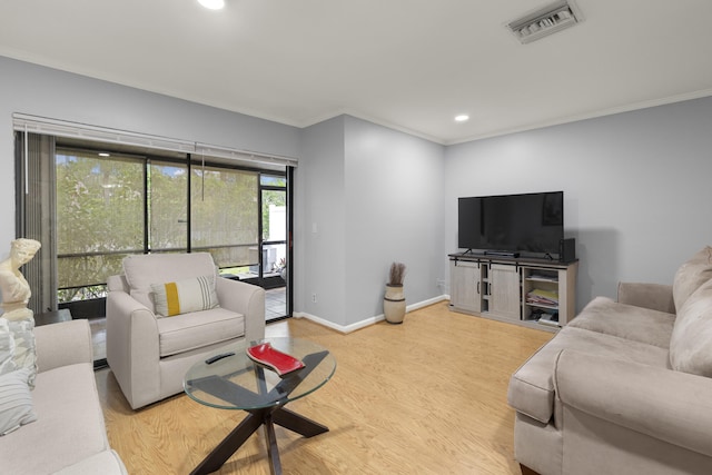 living area featuring wood finished floors, baseboards, ornamental molding, visible vents, and recessed lighting