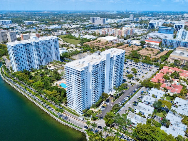 birds eye view of property with a water view and a city view