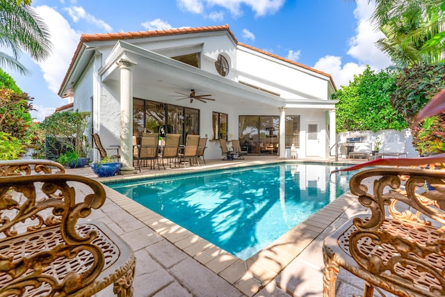 2133 NW 57th St, Boca Raton, FL 33496 - back of property with stucco siding, a fenced in pool, a patio area, outdoor dining space, and a ceiling fan