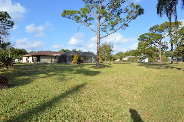 view of yard featuring a lanai