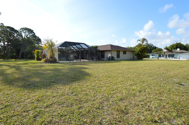view of yard with glass enclosure