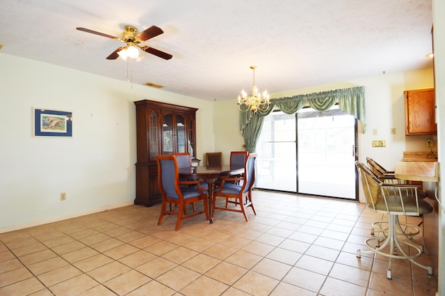 dining area featuring ceiling fan with notable chandelier, visible vents, and light tile patterned flooring