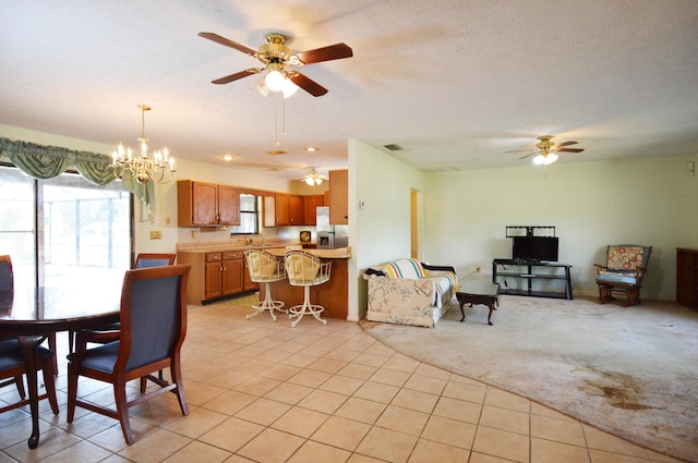 dining area with light tile patterned floors, light carpet, a textured ceiling, and ceiling fan with notable chandelier