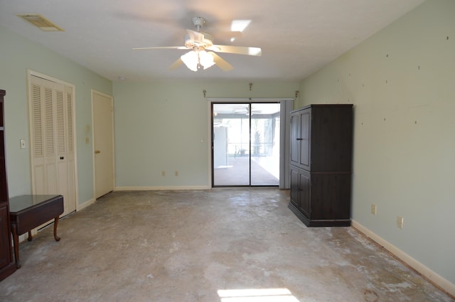 unfurnished bedroom with visible vents, baseboards, a ceiling fan, concrete flooring, and access to outside