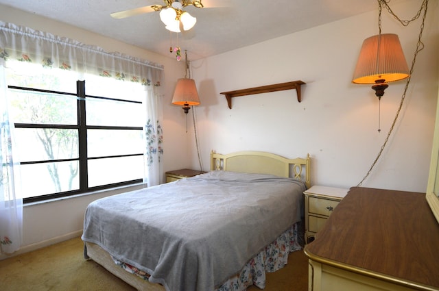 bedroom featuring light carpet and baseboards