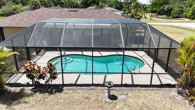 pool with a lawn, a patio area, and a lanai