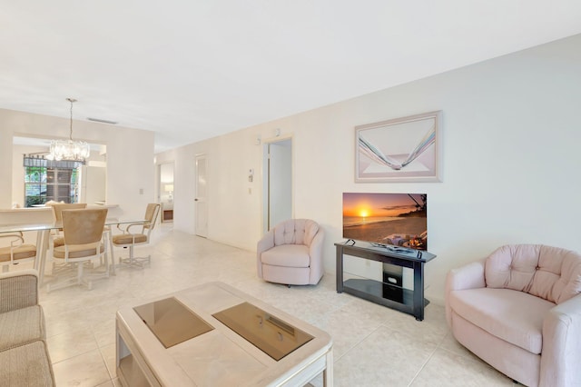 living area featuring visible vents, light tile patterned flooring, and a chandelier
