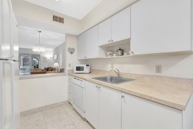 kitchen with visible vents, white appliances, light countertops, white cabinetry, and a sink